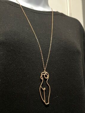 female form gold tone necklace